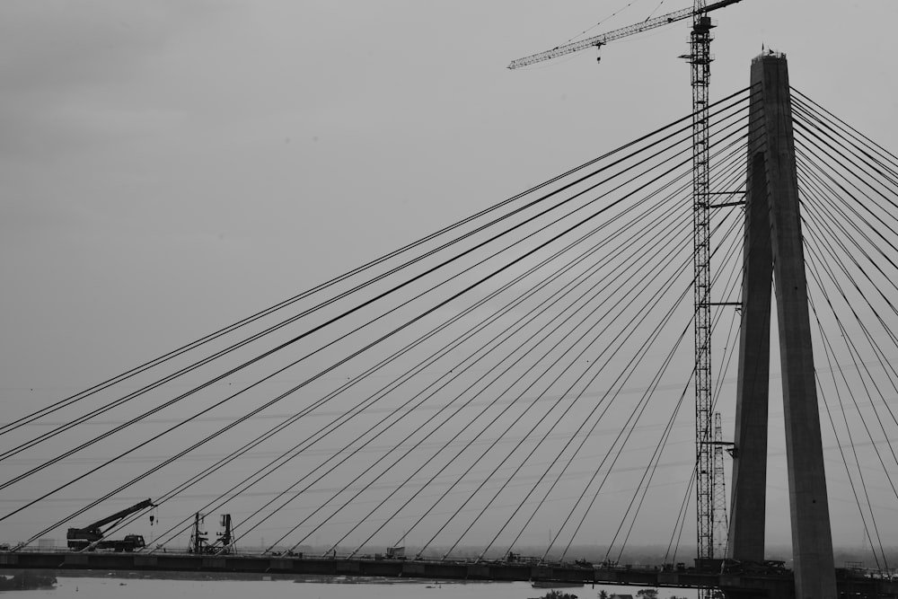 a black and white photo of a bridge under construction