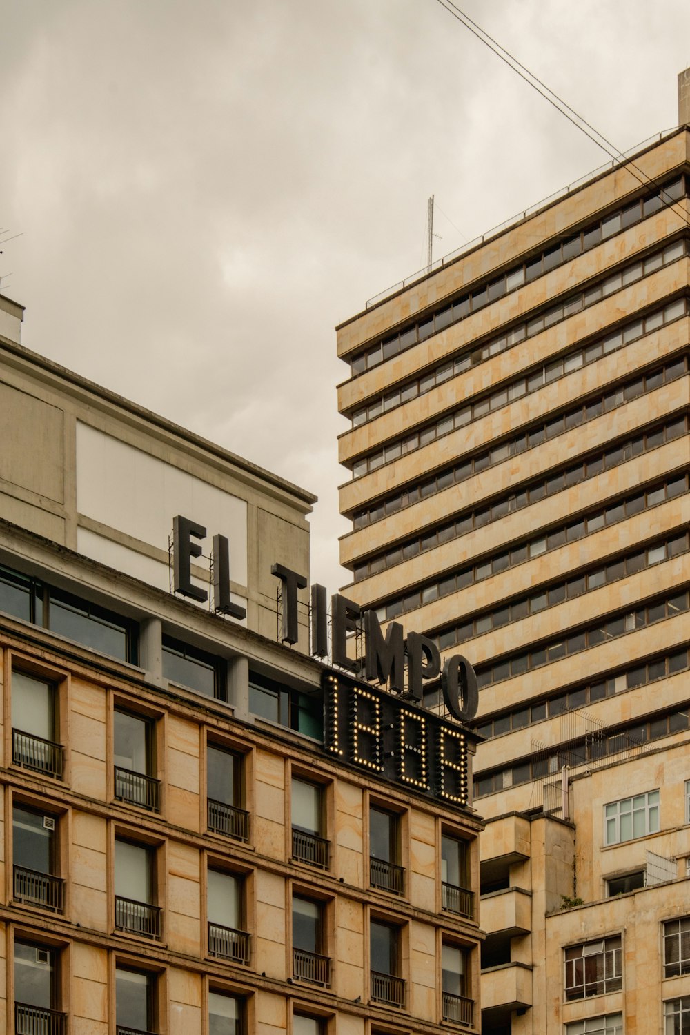 a tall building with a sign on top of it