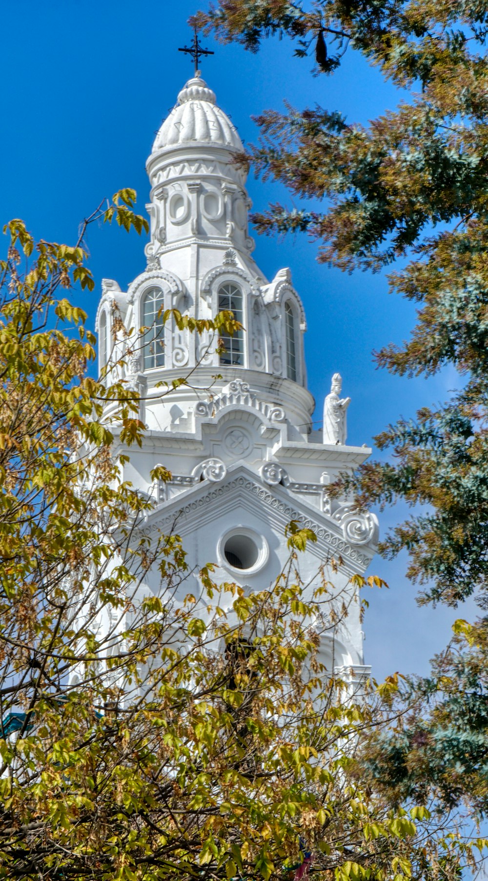 a tall white building with a clock on it's side