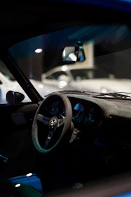 Detailed shot of the car’s leather interior showcasing the dashboard and steering wheel.