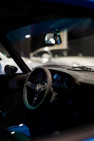 Interior shot of a spacious, clean driving school car with modern seats and steering wheel.