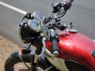 Close-up of a biker's hands gripping the handlebars of a Goldwing motorcycle on a mountain road.