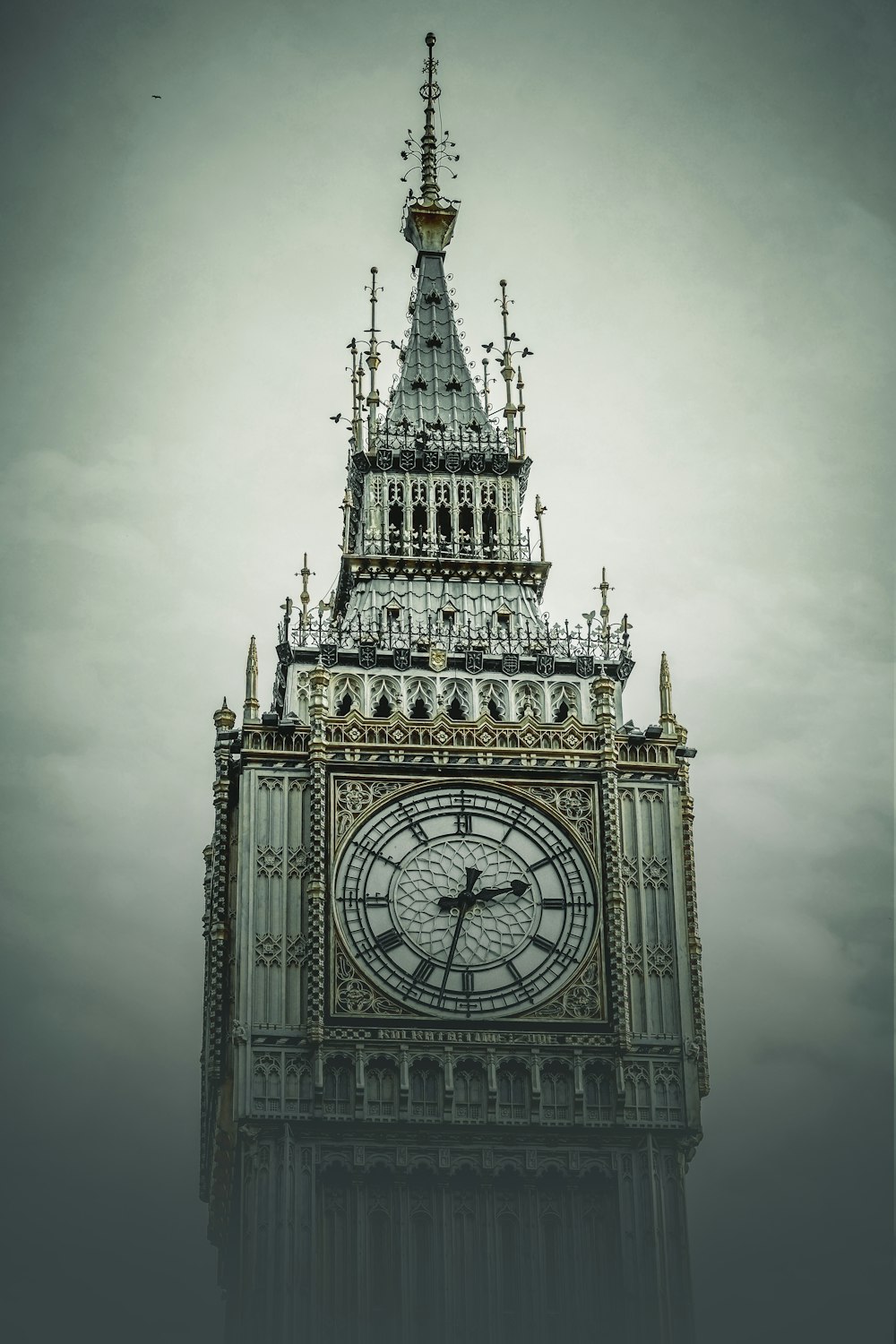 a tall clock tower with a clock on each of it's sides