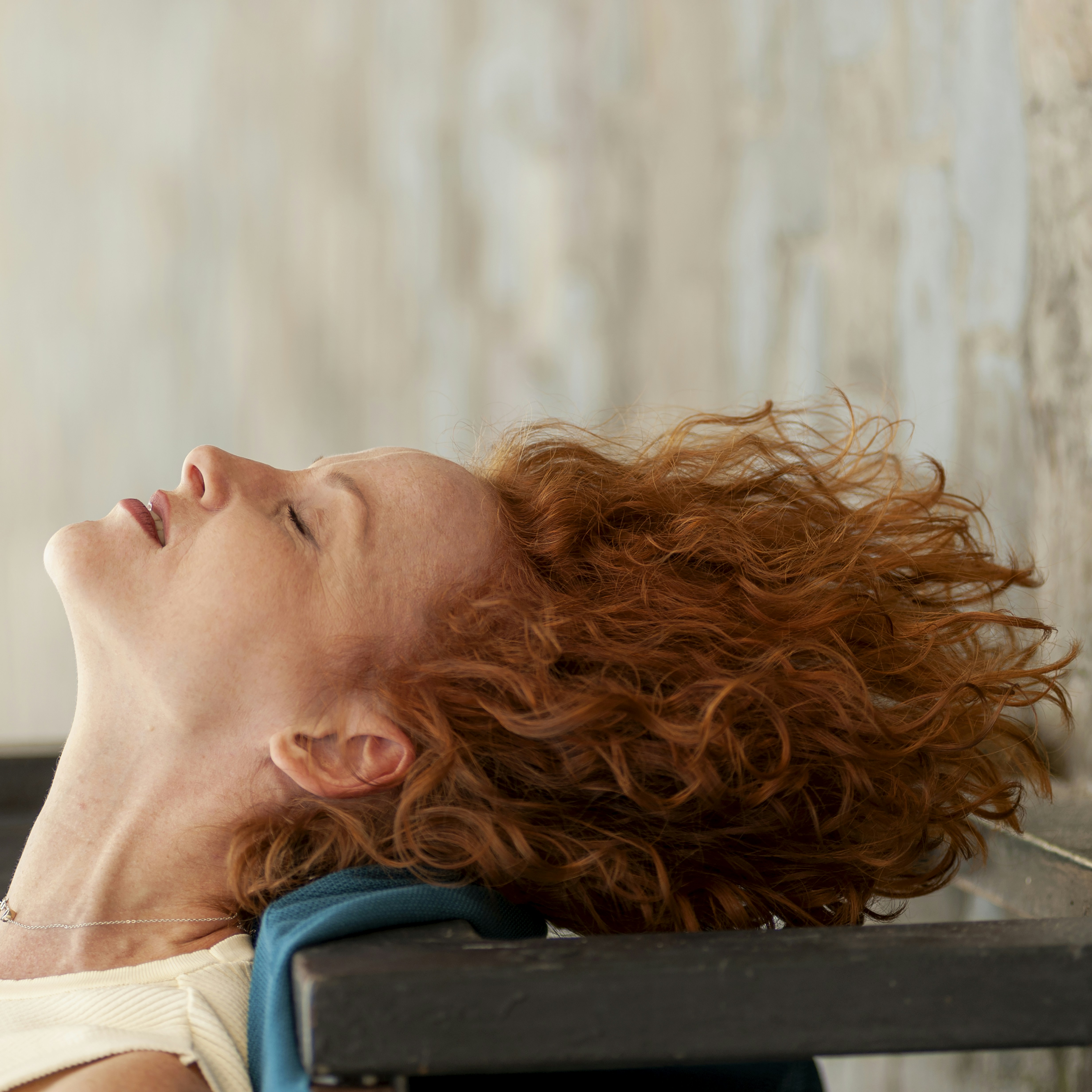 6 Simple Ways to Overcome Jet Lag and Feel Fresh Faster – a woman with red hair laying on a bench