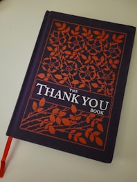 An animated style thank you book open with colorful illustrations.