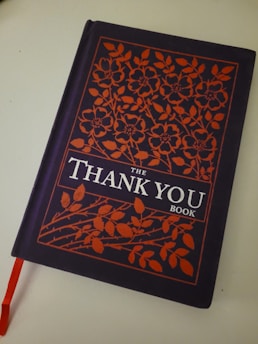 An animated style thank you book open with colorful illustrations.