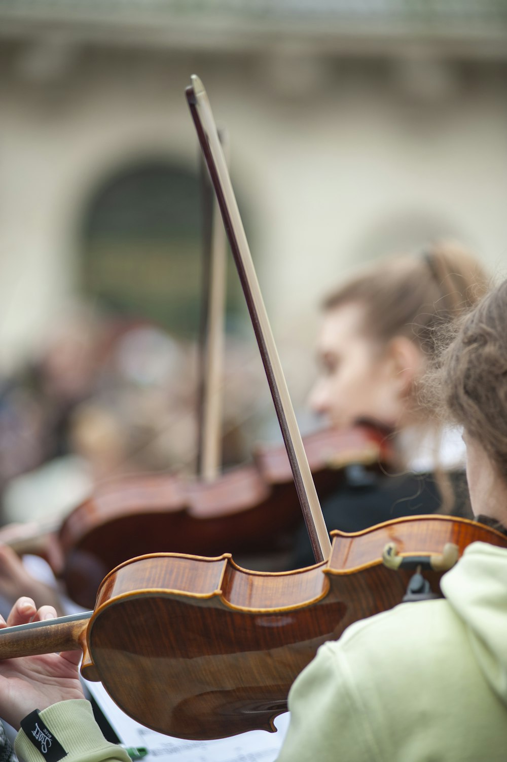 a close up of a person playing a violin