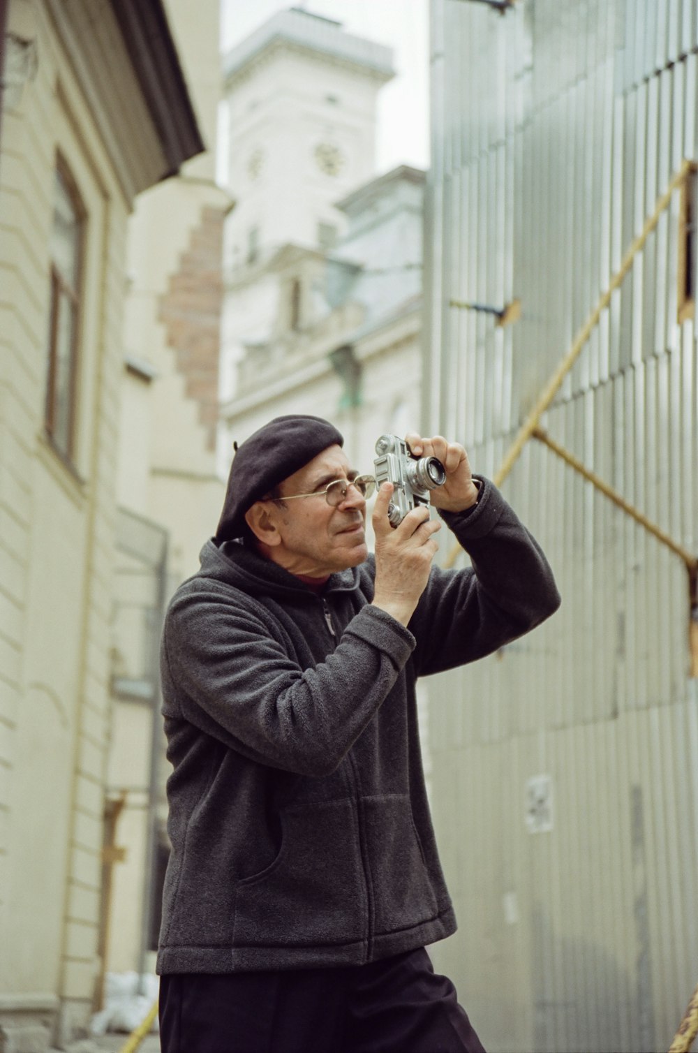 a man taking a picture of a building with a camera