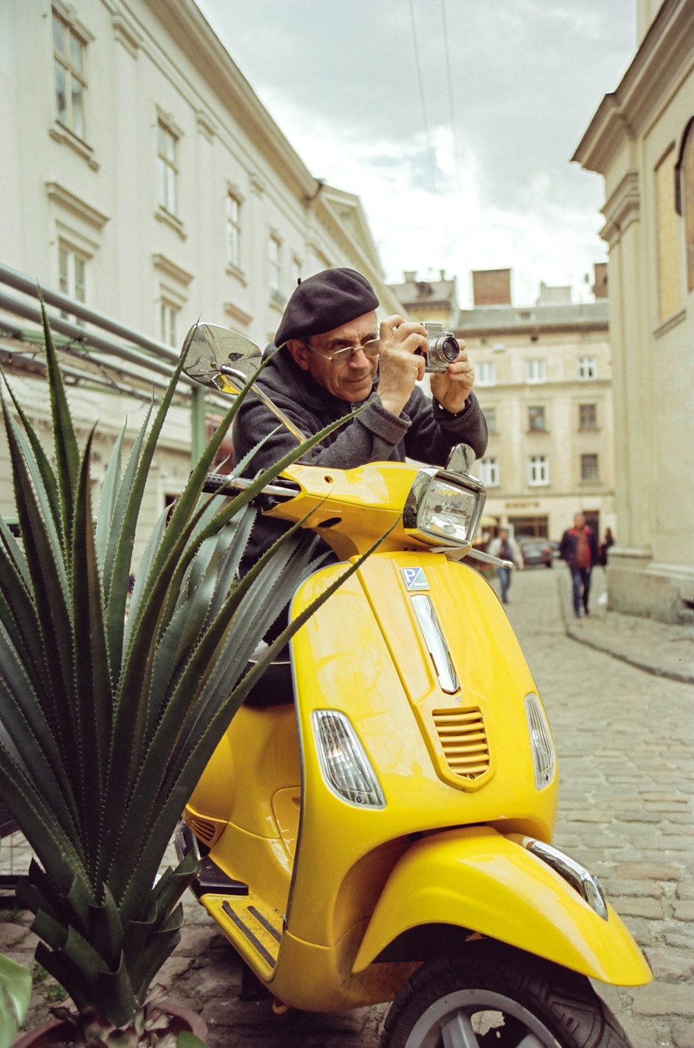 a man taking a picture of himself on a yellow scooter