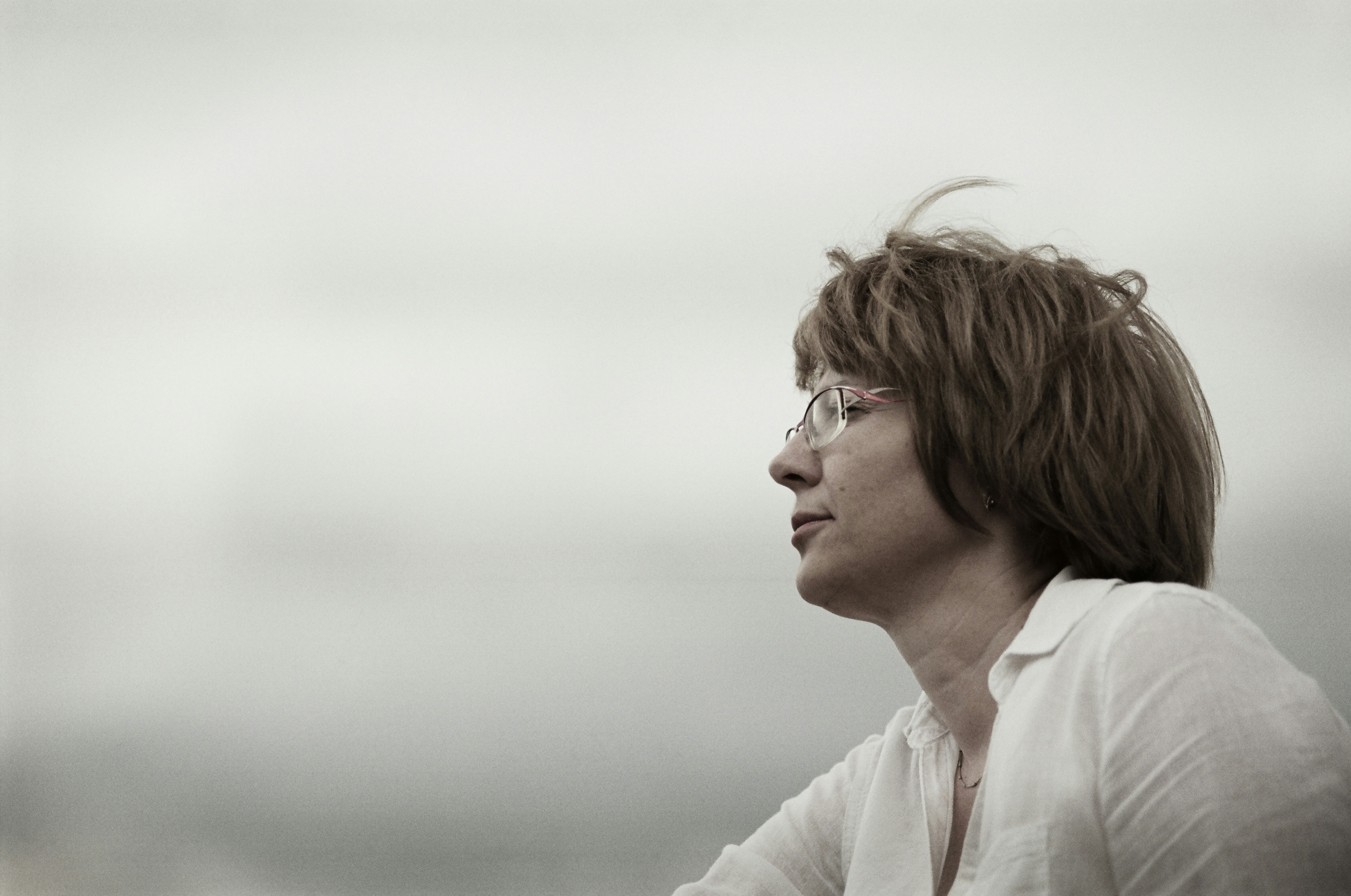 Mature woman with glasses looking off into the distance