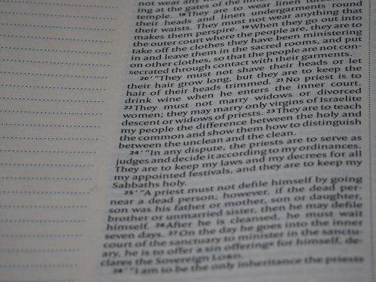 A close-up photograph of a printed page from a book. The text is formatted in a column, with paragraphs detailing religious or historical instructions related to priests. The page includes both printed text and a blank section on the left with a series of dotted lines, possibly for notes or annotations.