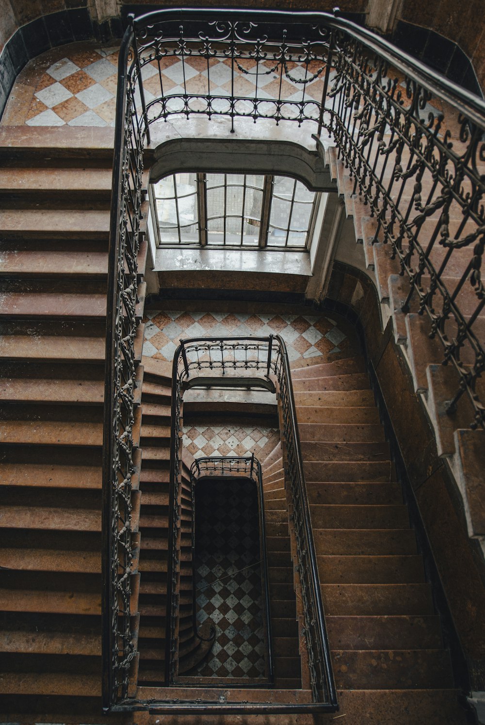 a stair case with a wrought iron railing