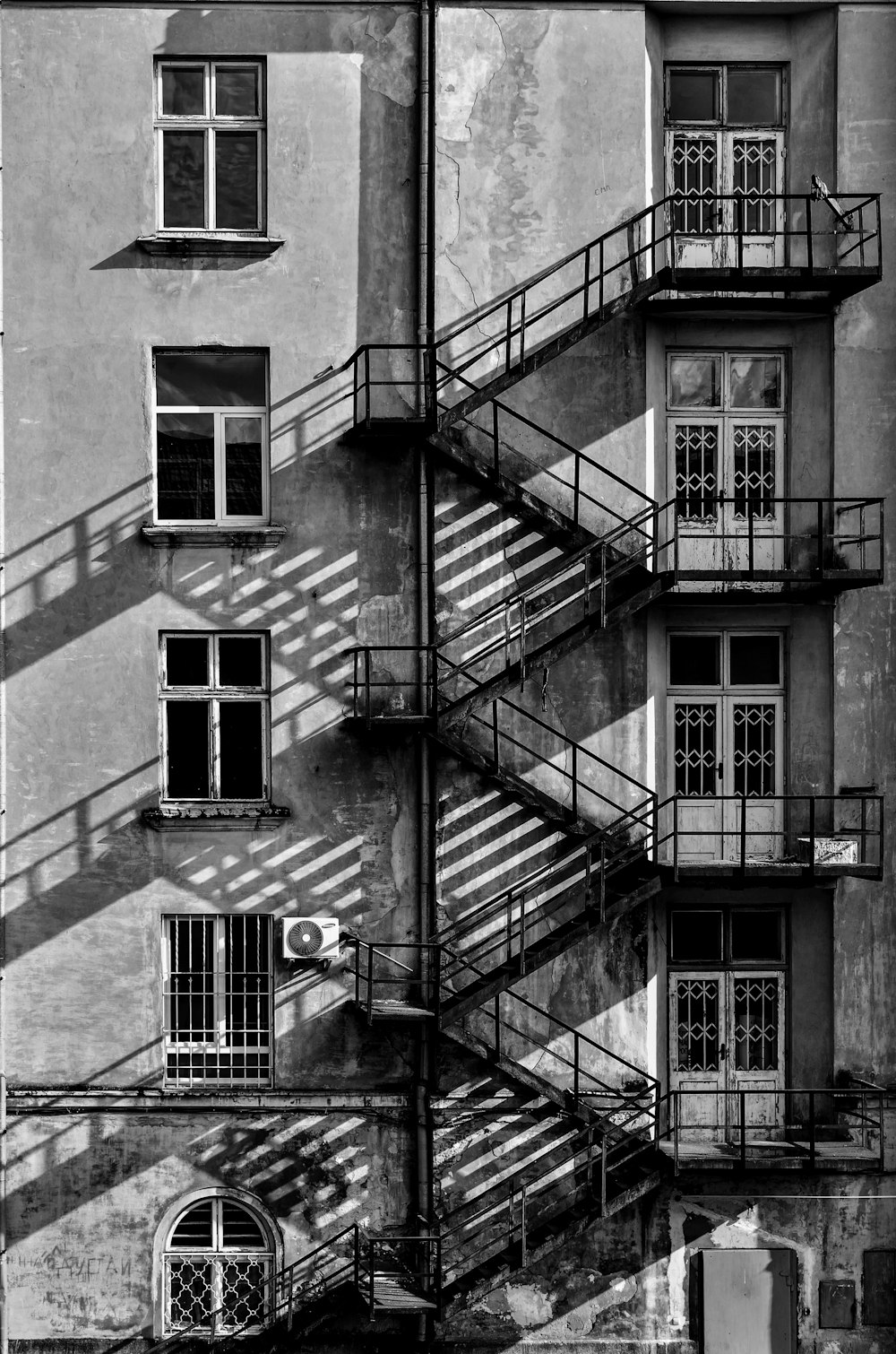 a black and white photo of a building with stairs