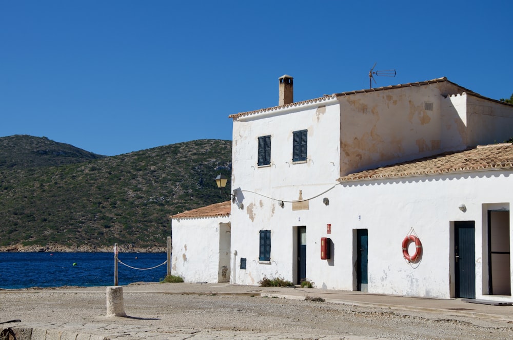 a white building with a red wreath on the front of it