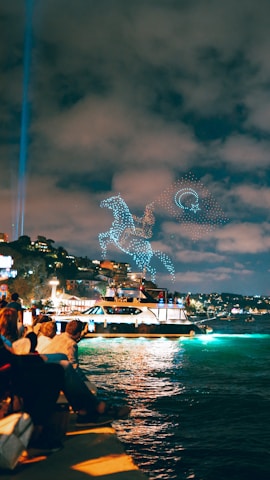 A synchronized drone light show illuminating the night sky.