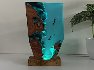 A deep sea lamp with divers descending