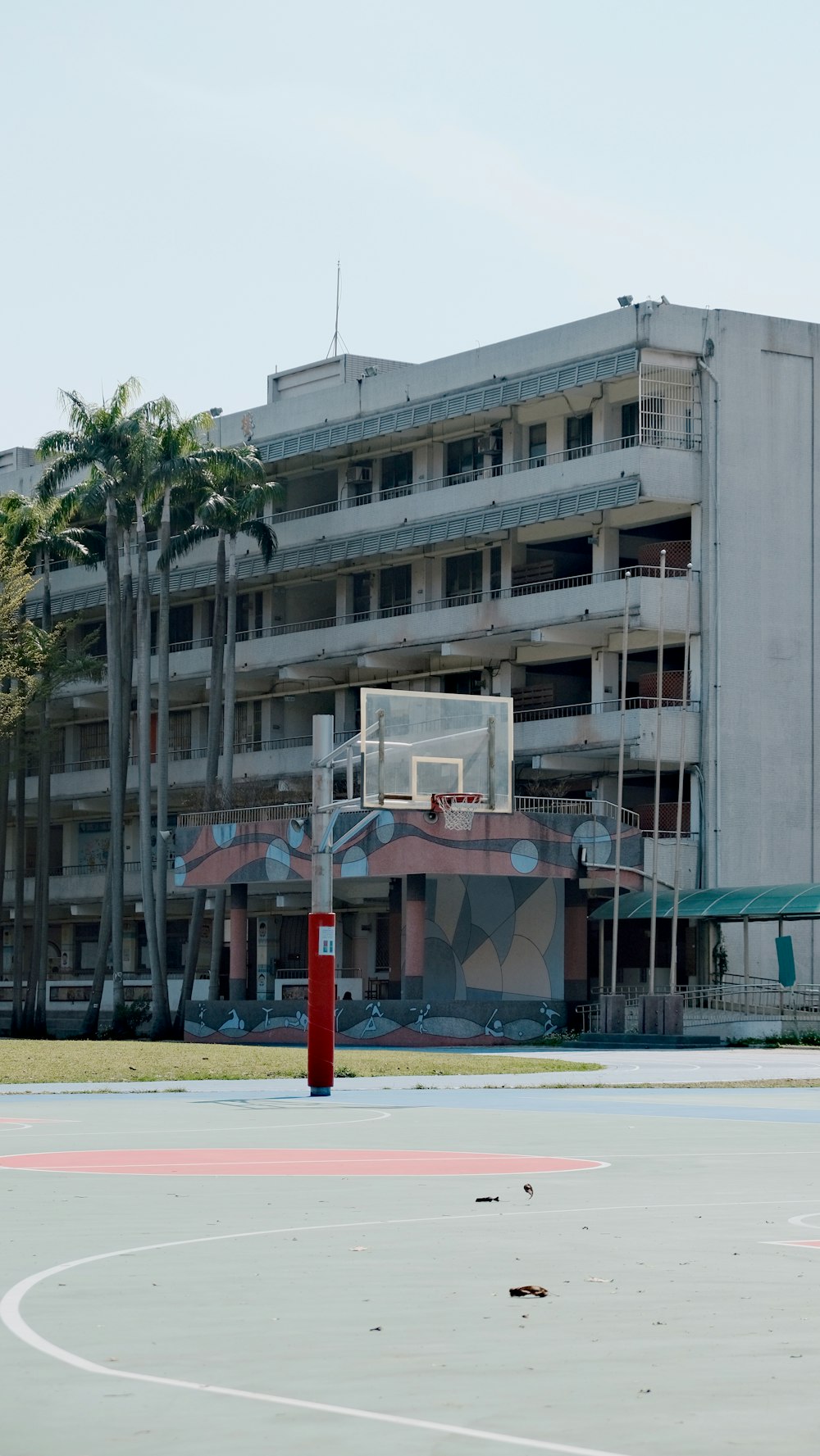 a basketball court in front of a large building