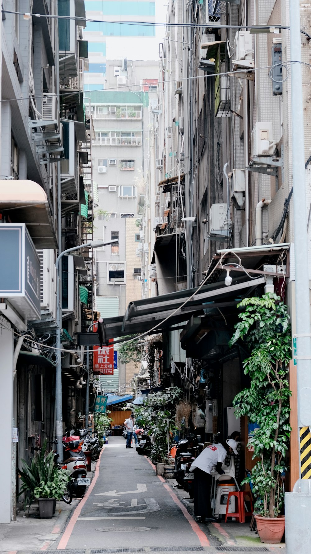 a narrow city street lined with tall buildings