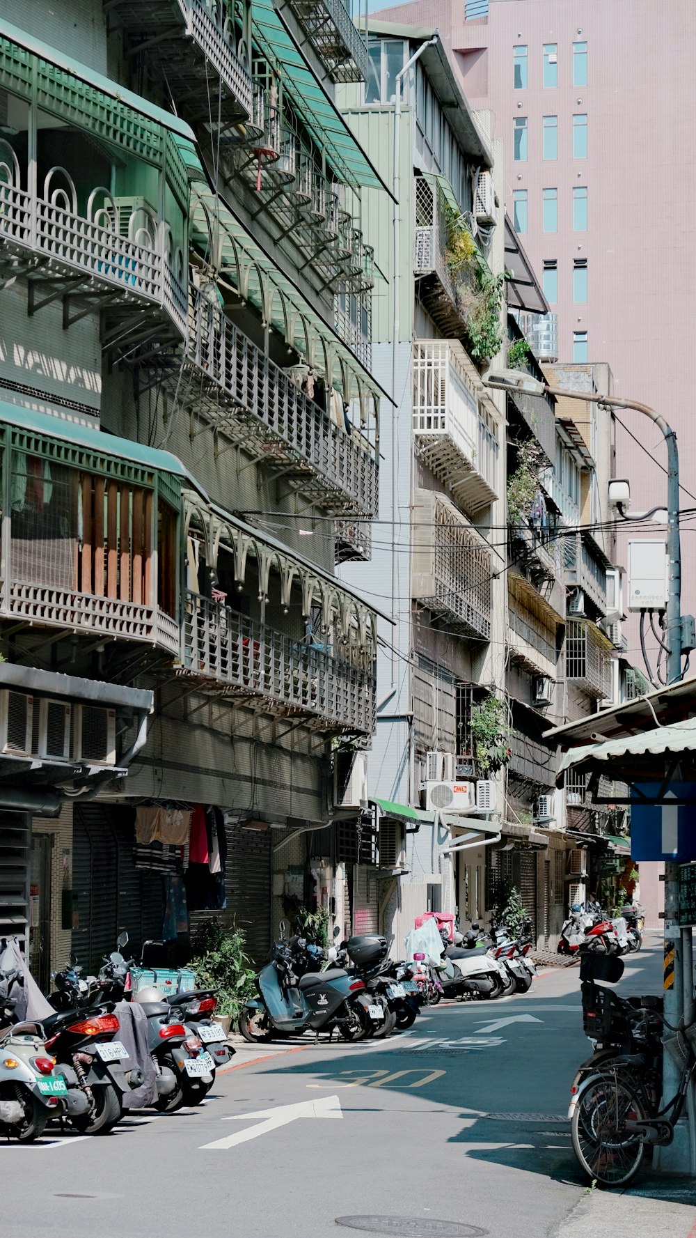 a city street filled with lots of parked motorcycles