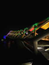 A vibrant neon green bridge symbolizing connection between two groups of people.