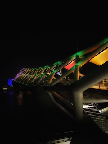 A vibrant neon green bridge symbolizing connection between two groups of people.