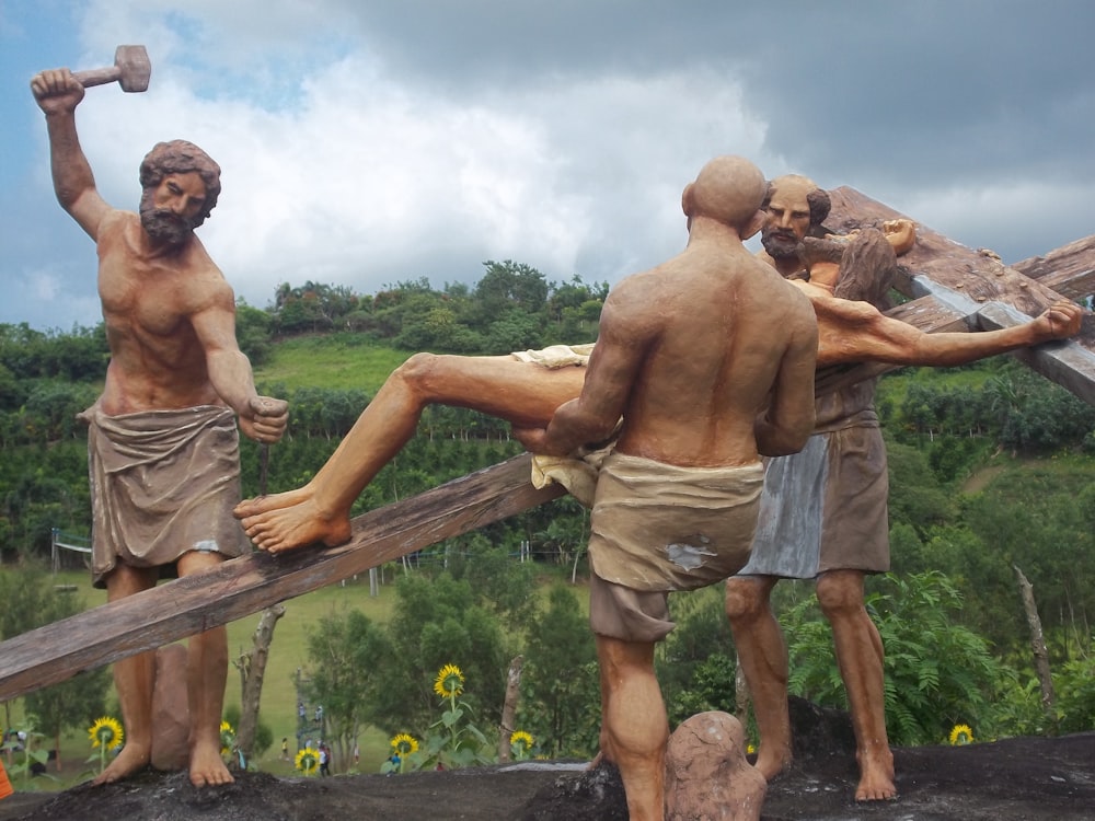 a statue of a man being nailed to a cross