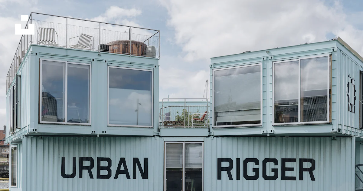 A couple of shipping containers sitting on top of a body of water photo ...