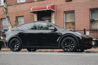 a black car parked on the side of the road