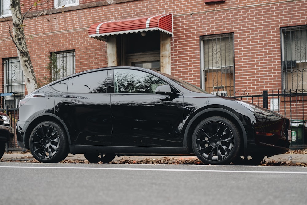 a black car parked on the side of the road