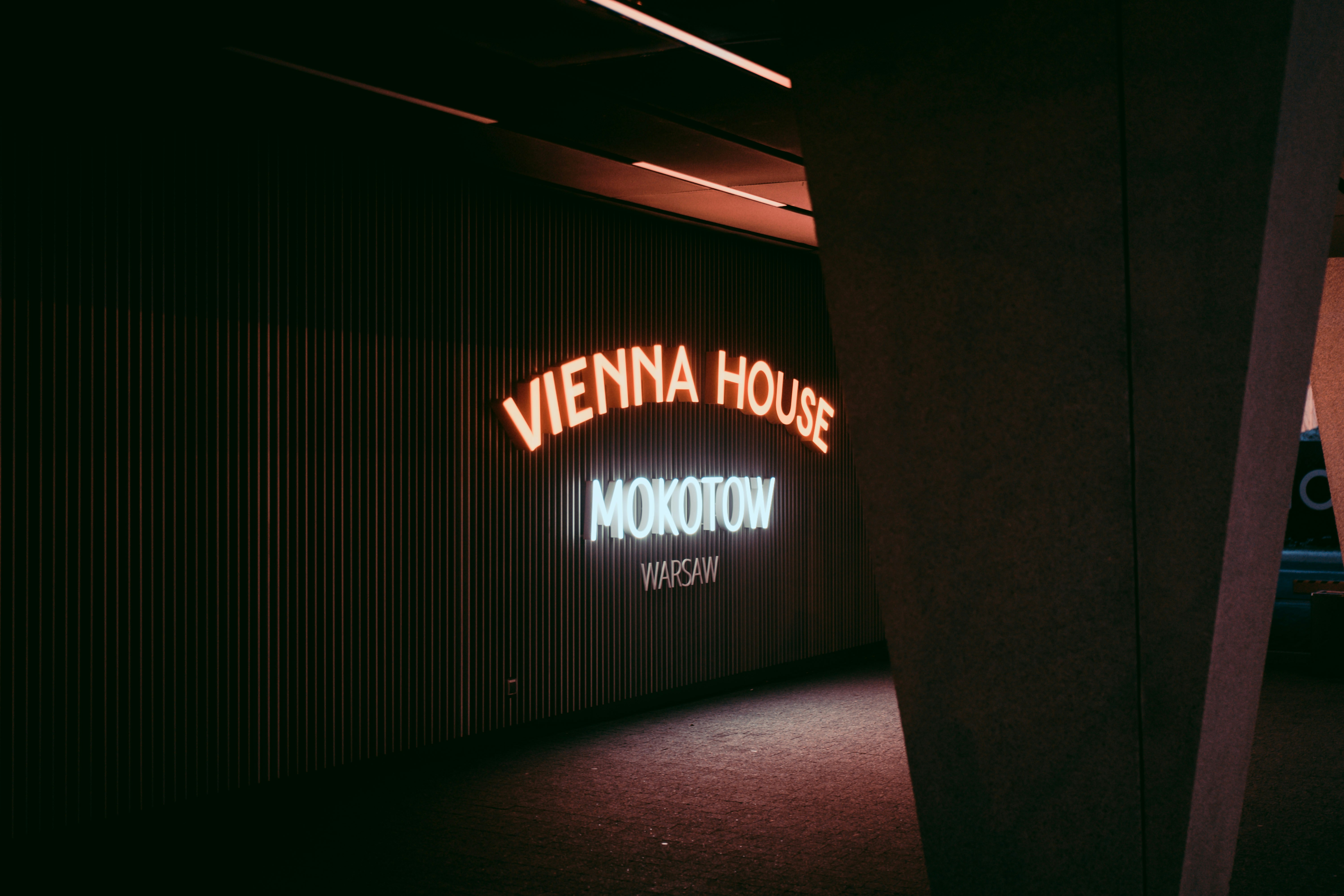 a neon sign is lit up in a dark room