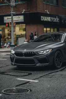 a grey car parked on the side of the road