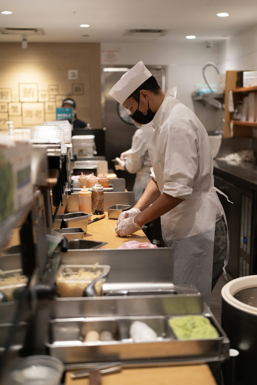 a man standing in a kitchen preparing food