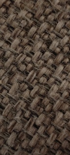Close-up of woven textile with natural fibers and earthy tones.
