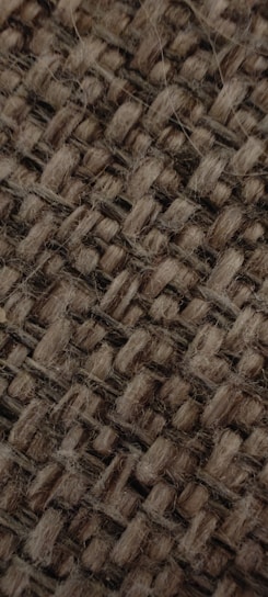 Close-up of handwoven herbal fabric with natural dye patterns in earthy tones