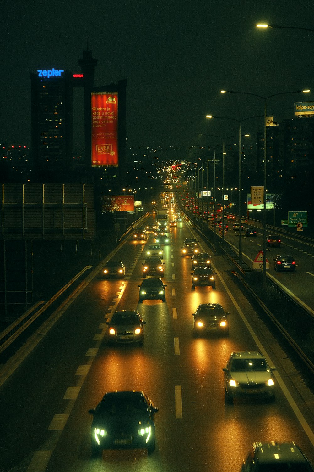 a city street filled with lots of traffic at night