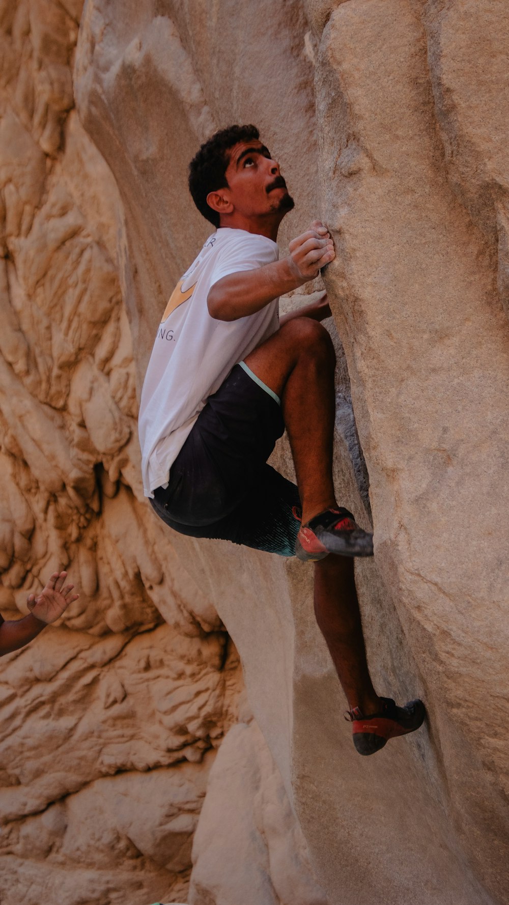 a man climbing up the side of a mountain