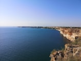 An aerial view of a coastline with energy-generating structures.