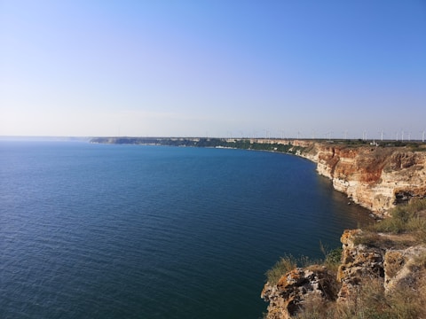 An aerial view of a coastline with energy-generating structures.