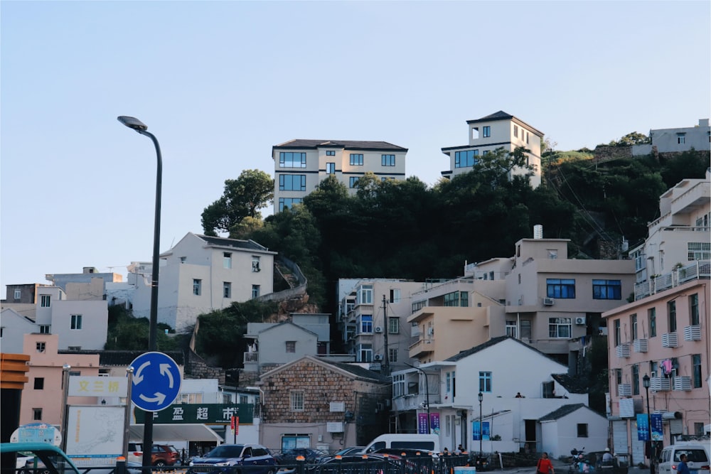 a city with lots of tall buildings on top of a hill