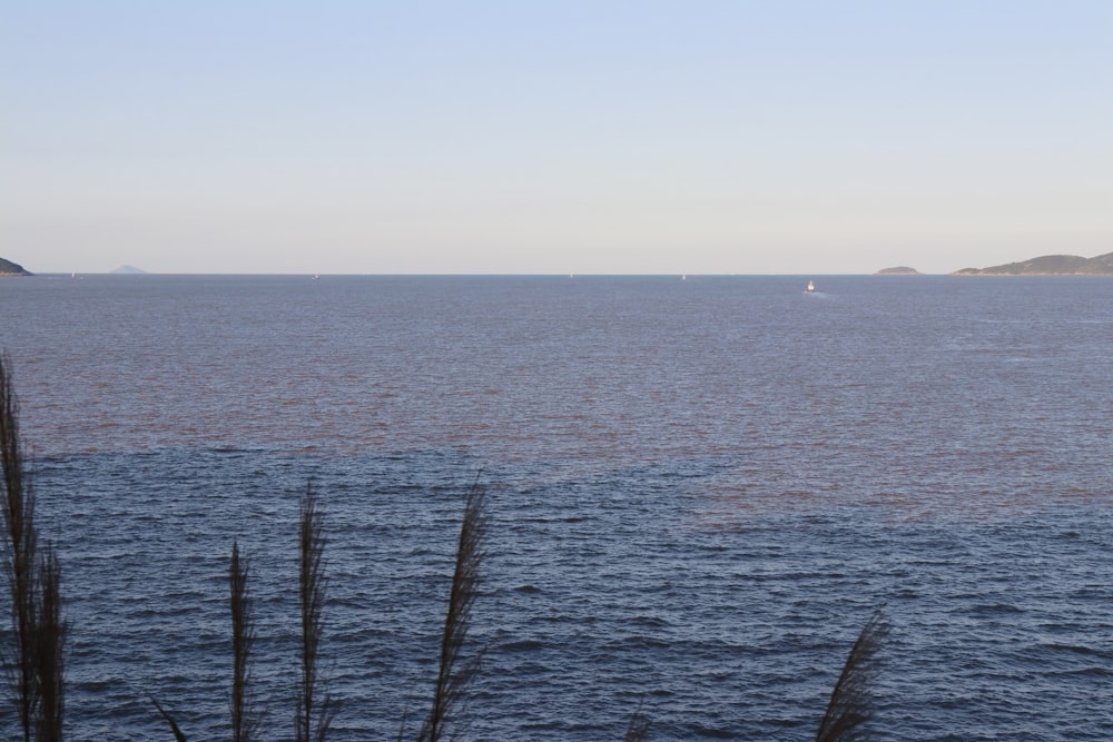 a body of water with a boat in the distance