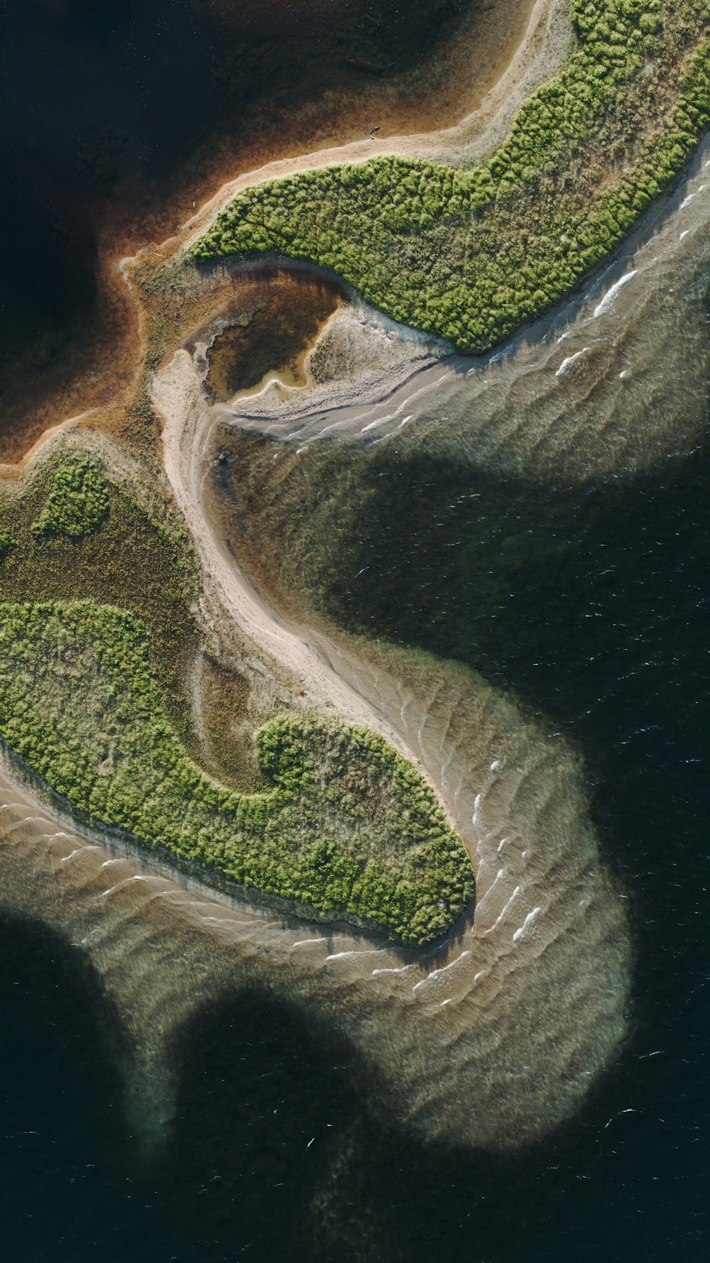 an aerial view of a river and land