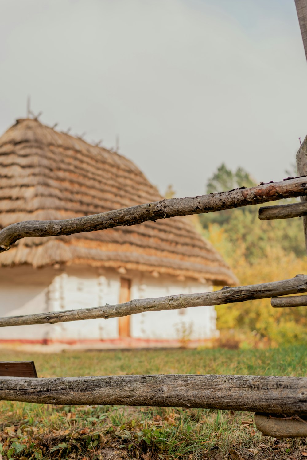 a wooden fence with a house in the background