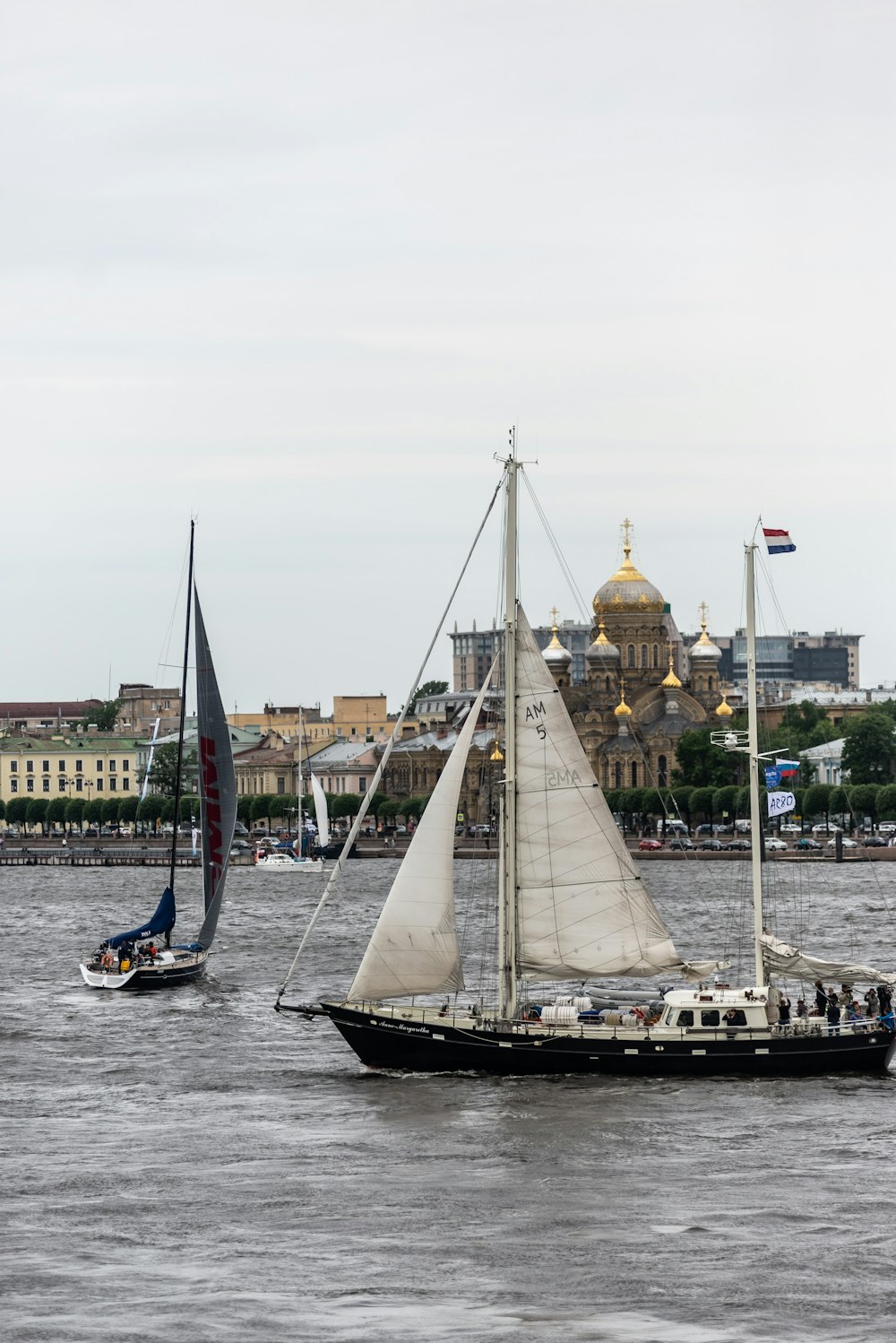 a sailboat and a sailboat in a body of water