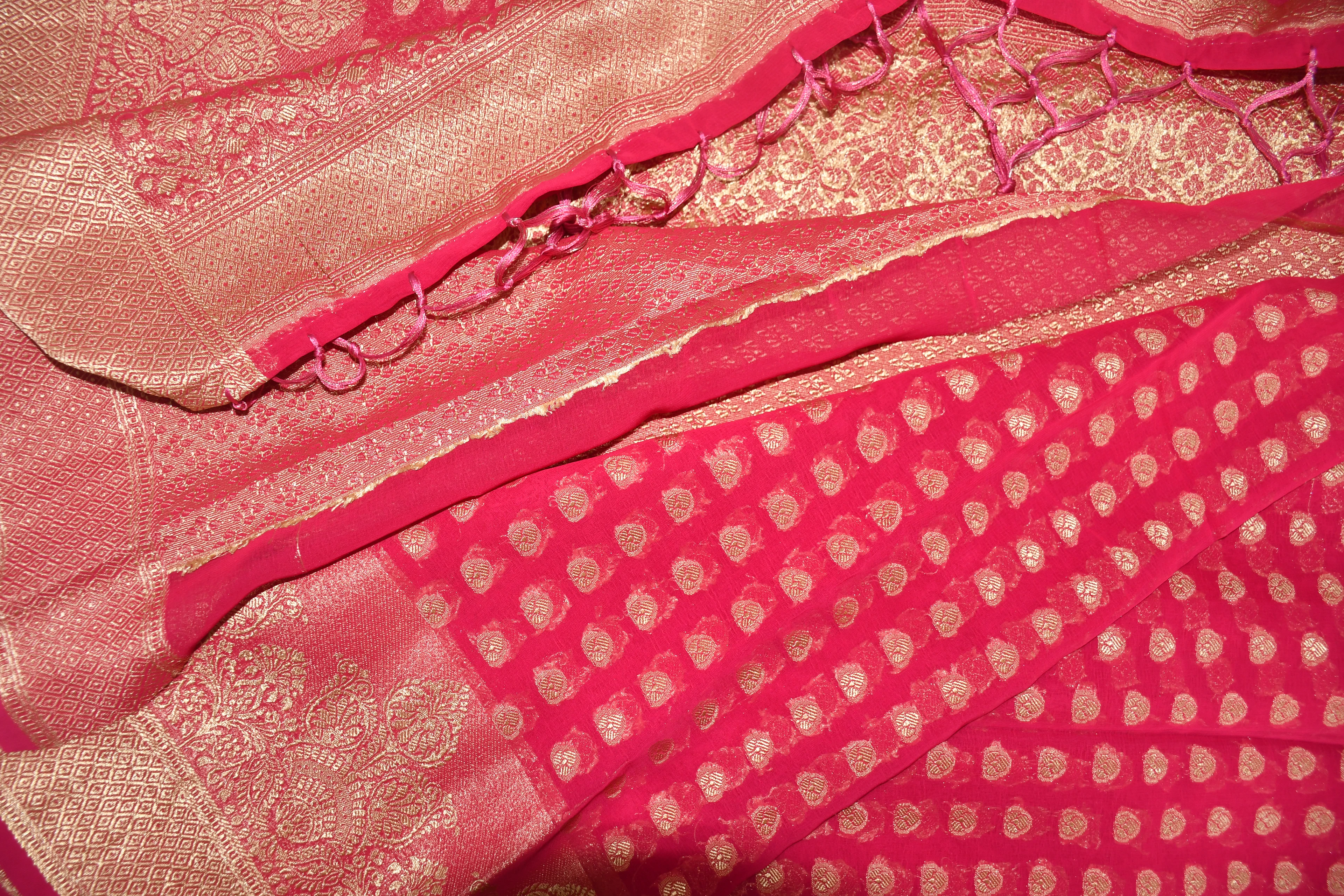 Close-up of pink silk with gold zari border