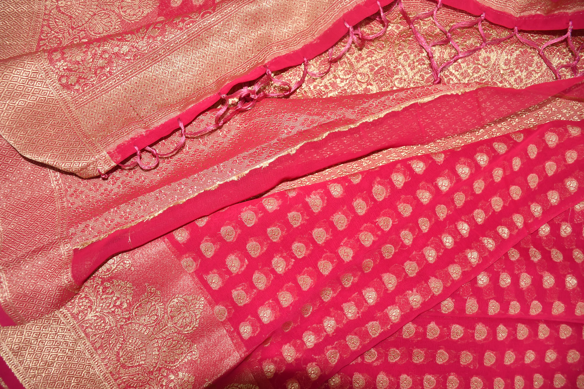 Close photograph of a richly woven silk with a gold border