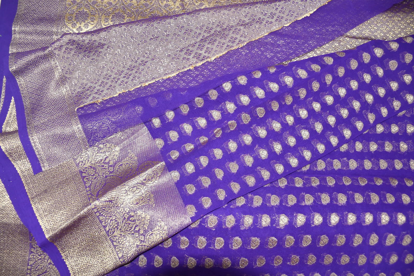 Close up of a purple and silver silk saree