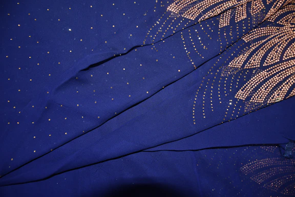 Elegant navy blue and gold celestial-themed background with subtle zodiac and gemstone motifs.