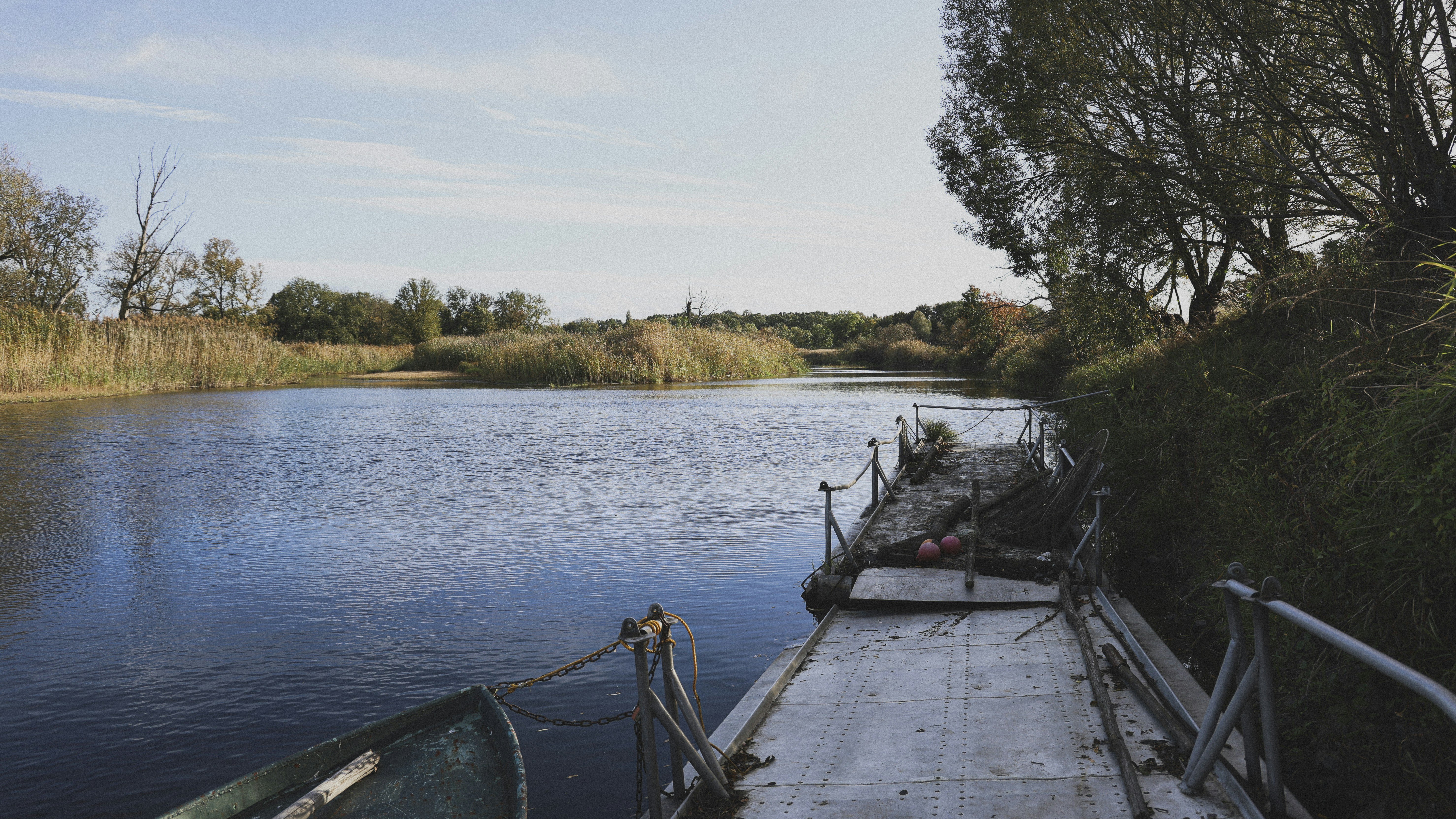 a boat is docked on the side of a river