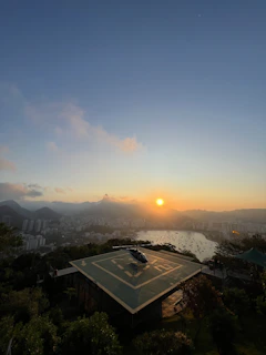 Aerial view of a modern helipad built on a rooftop in Mexico City at sunset.