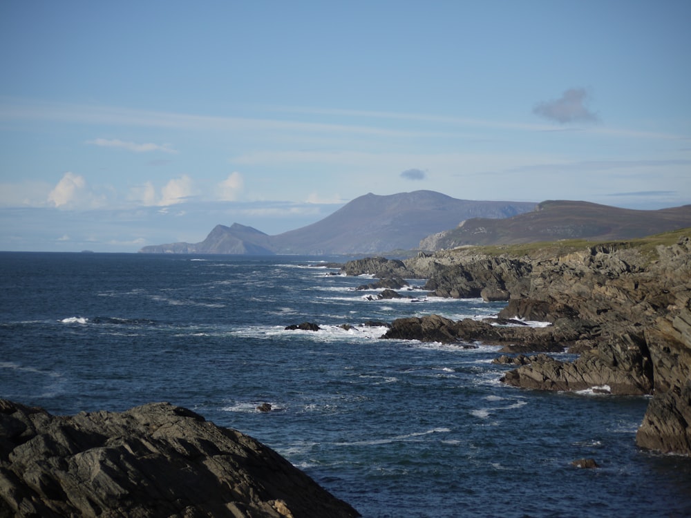 a view of the ocean with mountains in the background